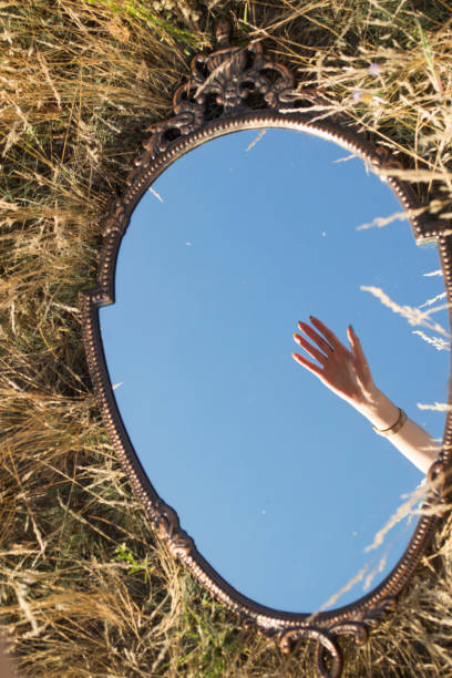 istock A woman's hand in reflection of the mirror. 1329750508
