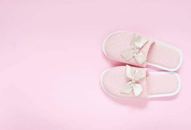 istock Pink home slippers on a pastel pink background. Top view. Copy space 1329750887