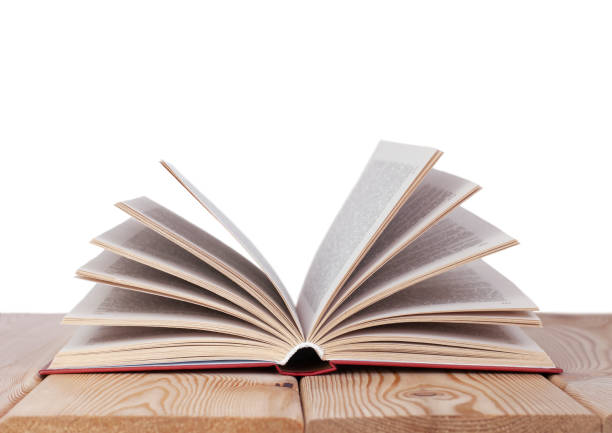 istock Isolated open book on the wood table 1329751096