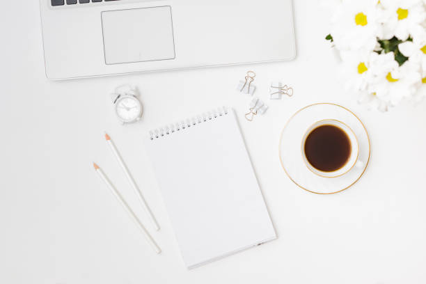 istock Mockup white notebook, laptop, cup of coffee on a white background 1329751907
