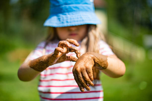 istock Little girls playing in sand-pit 1329752269