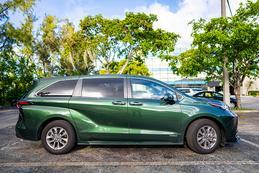 Miami, FL, USA - July 16, 2021: 2021 Toyota Sienna hybrid all wheel drive minivan in green