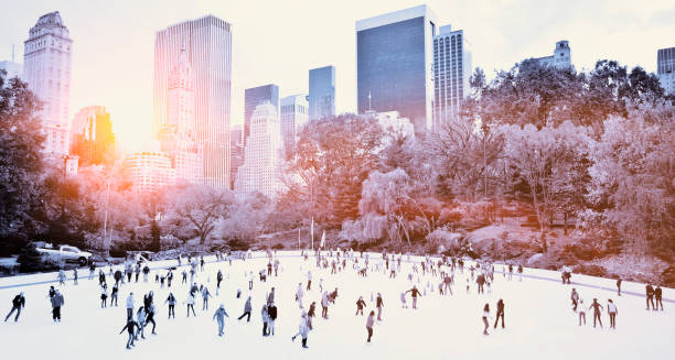 Skating in New York Ice skaters having fun in New York Central Park in fall with sunrise effect ice skating stock pictures, royalty-free photos & images