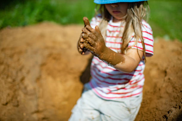 istock Little girls playing in sand-pit 1329754288