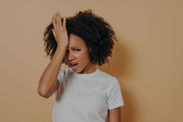 istock Young stressful african woman with hand on forehead suffering from strong headache or head migraine 1329754591
