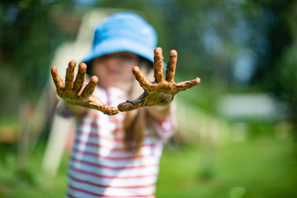 Little girls playing in sand-pit
