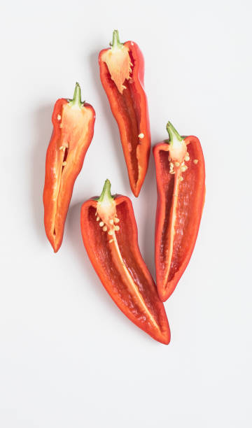 istock Split Red Peppers with Seeds and Pulp on White Background 1329757274
