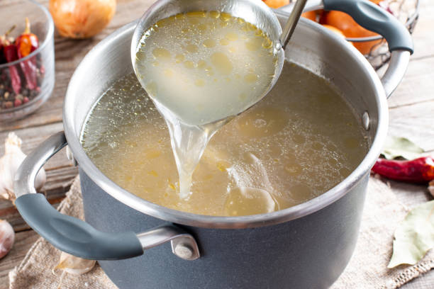 istock Saucepan with bouillon with a ladle. Bone broth 1329758206