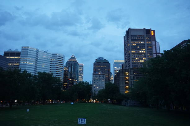 A skyline of Downtown, Sherbrooke street at the twilight blue hour Montreal, QC, Canada - 7-15-2021: A skyline of Downtown, Sherbrooke street at the twilight blue hour. Foreground is McGill university lower field sherbrooke quebec stock pictures, royalty-free photos & images