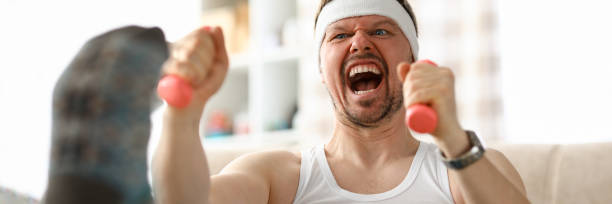 istock Guy doing exercises with dumbbells in his hands 1329758897