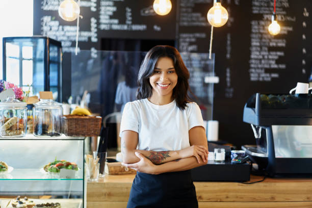 istock Smiling barista standing in cafe. Small business concept 1329759064