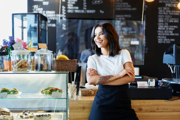 Happy female cafe owner standing. Small business concept. stock photo
