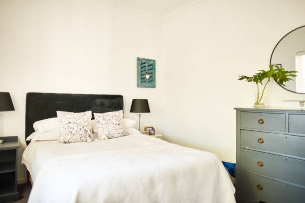 istock Comfortable bed and drawers in a contemporary bedroom 1329761107