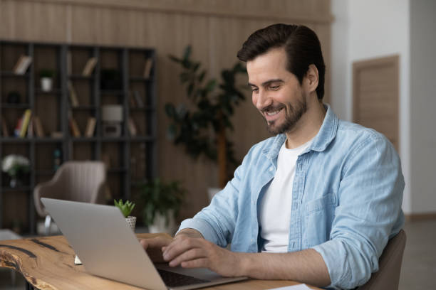 istock Happy millennial businessman working on online project on computer. 1329763160