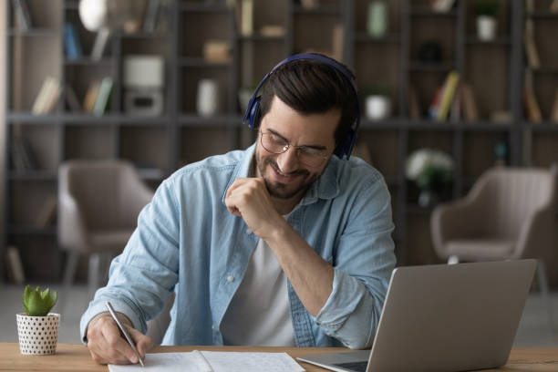 istock Happy motivated young 30s man listening educational lecture. 1329763162