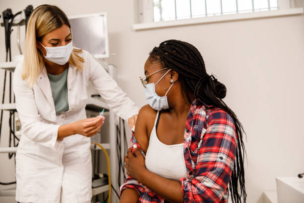 istock Disinfecting her arm before injecting the vaccine 1329763204