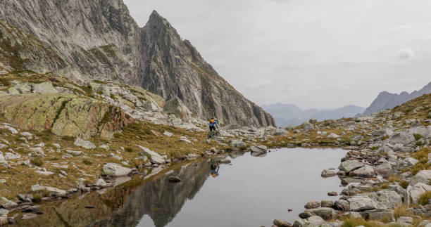 istock Mountain biker rides along alpine mountain ridge 1329764207