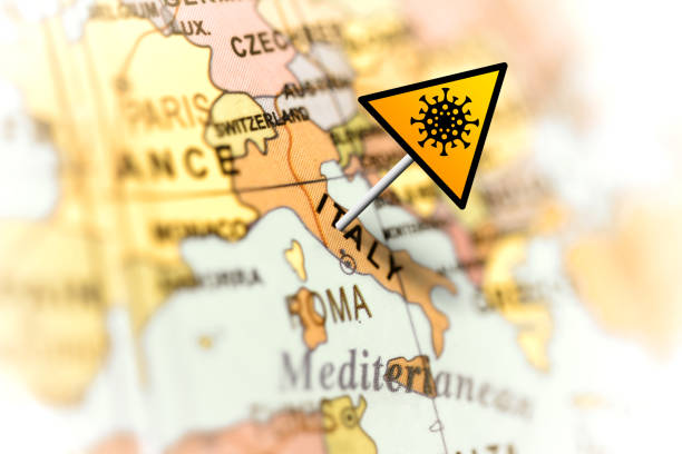 Yellow warning sign of coronavirus in Italy on the map. Covid-19 infection concept.