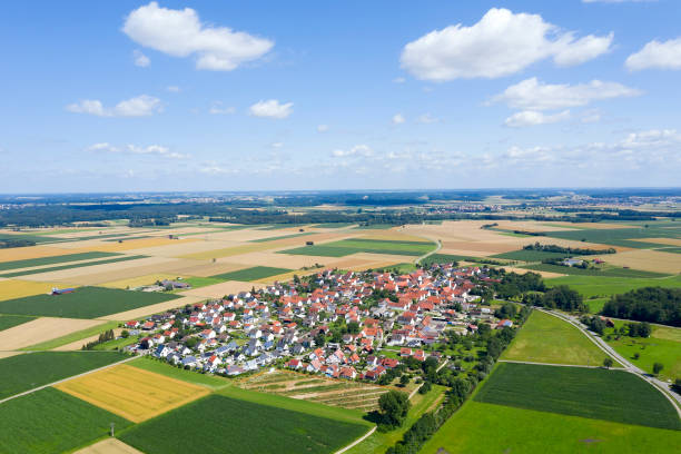 Idyllic summer aerial landscape with a small town, blue sky with cumulus clouds.