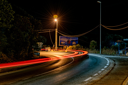 Utjeha, Montenegro - July 09, 2021: Abstract car lights at night. Light Trails at Nigh