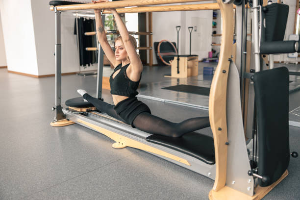 istock Proffesional beautiful slim caucasian woman is doing stretching exercises in modern studio 1329772237