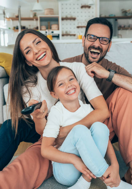 istock Family watching television 1329773786