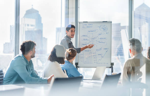 istock Business people watching a presentation on the whiteboard. 1329773892