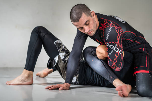 istock Brazilian jiu jistu bjj no-gi grappling training two male athletes drilling technique kimura trap copy space 1329779376