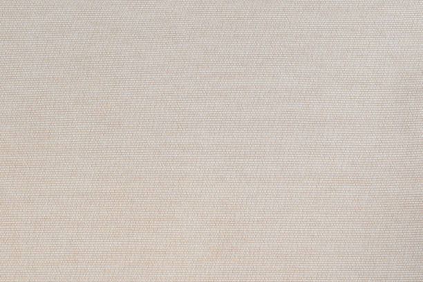 istock Cotton silk fabric wallpaper texture pattern background in light pastel beige cream brown color tone 1329779485