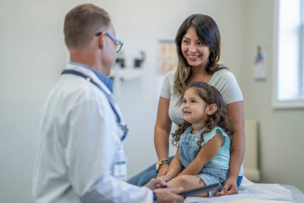 istock Mother and daughter go to doctor's appointment 1329779743
