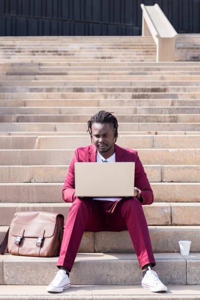 istock businessman works with his laptop on a staircase 1329780406