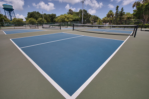 lLow angle view of tennis court from baseline corner.