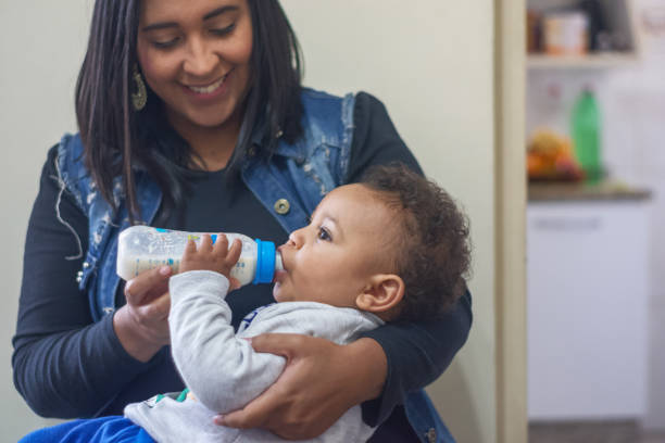 istock Young mother feeding her little baby 1329781459