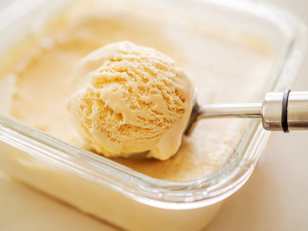 istock Vanilla ice cream with ice cream scoop 1329784127