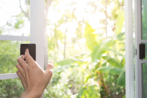 istock Hand holding open white window open with natural blurred background and sunlight 1329790150