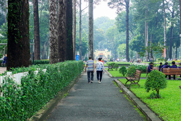 An elderly Asian couple walking in the park