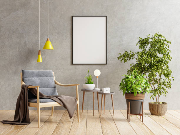 istock Poster mockup with vertical frame on empty dark concrete wall in living room interior with armchair. 1329797856