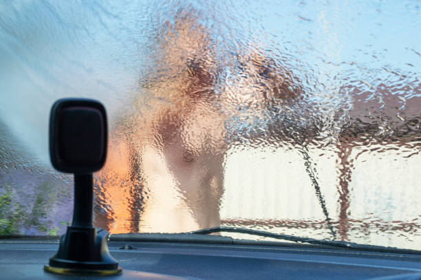 istock look through a blurred car windshield at a hand wash, flood 1329801200