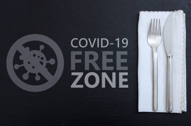istock Covid free zone sign. COVID-19 free zone text on restaurant table 1329802309