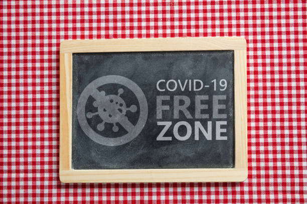 istock Covid free zone sign. COVID-19 free zone text on tavern table 1329802328