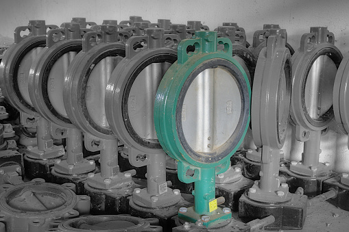 Old stocks of butterfly valves laid on the floor inside a warehouse