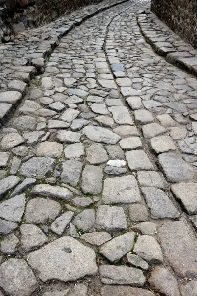 sinuous roman paving - stone path downhill with a deviation