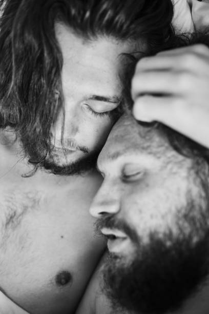 istock Portrait of two men hugging, close up 1329806077