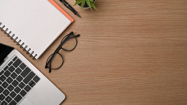 istock Top view simple workspace with computer laptop, glasses, notebook and houseplant. 1329806289