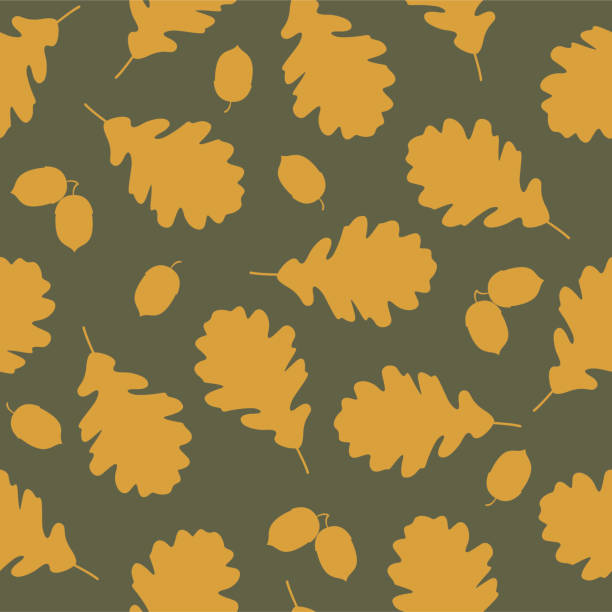 istock Orange silhouette oak leaves and acorns on taupe background. 1329814566