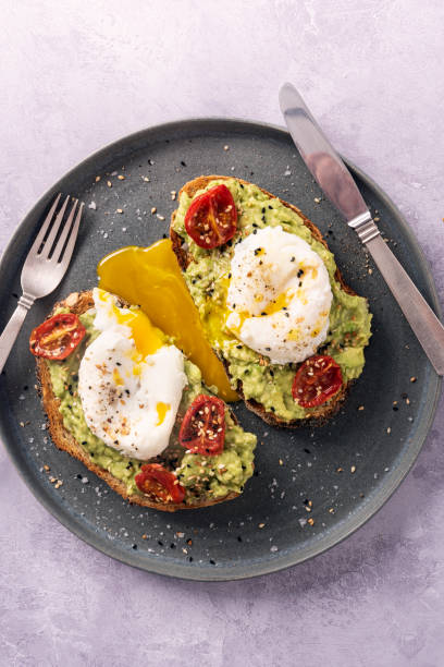 istock Avocado Toast with Eggs Benedict and Toasted Sesame Seeds. 1329818645