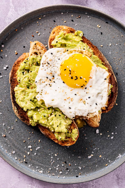 Avocado Toast with a Fried Egg and Toasted Sesame Seeds.