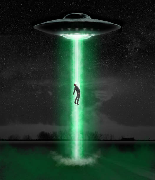 istock Man being abducted by UFO - alien abduction concept 1329818936