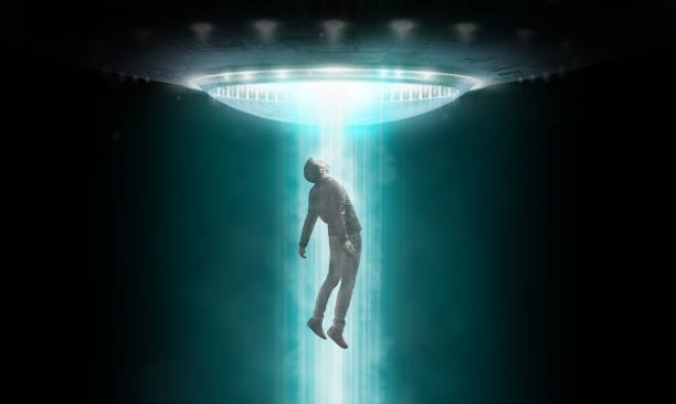istock Man being abducted by UFO - alien abduction concept 1329818982
