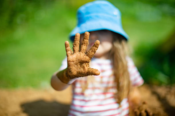 istock Little girls playing in sand-pit 1329819064